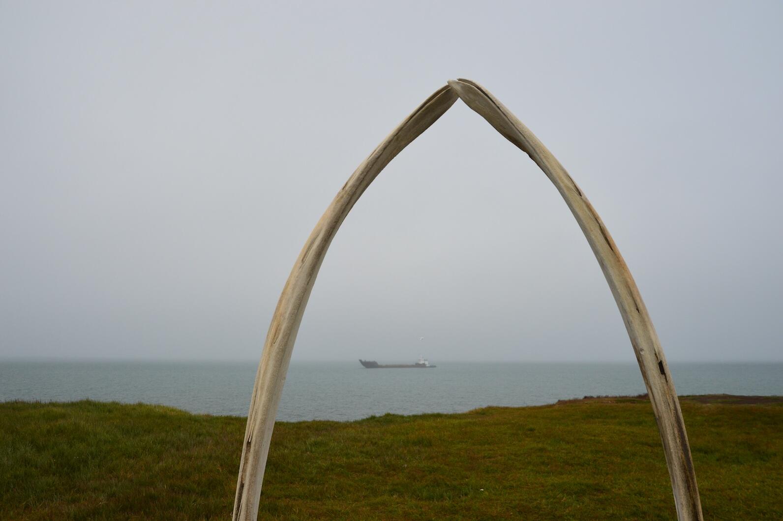 Whale arches against ocean with ship on water Whale arches against ocean with ship on water