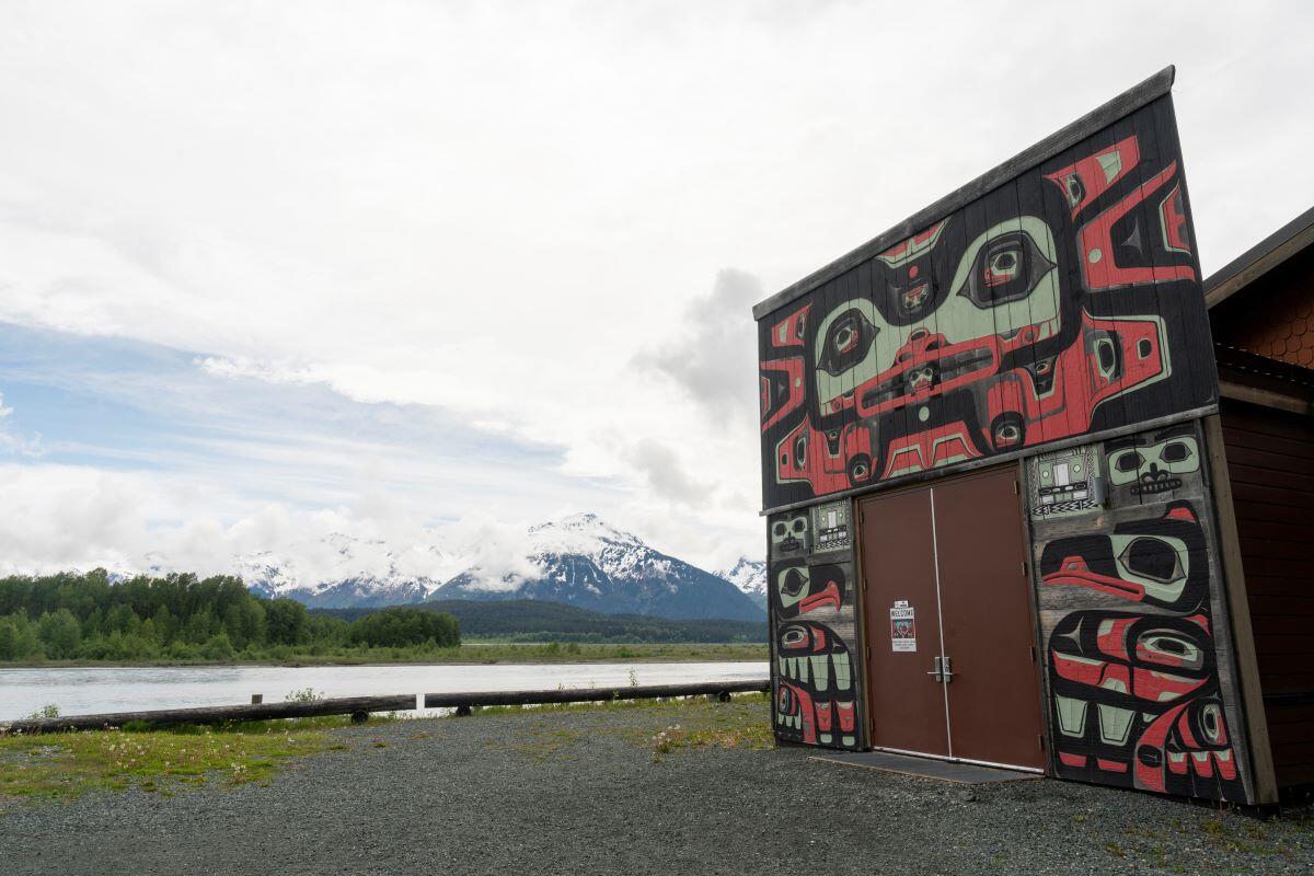 Building with Alaska Native art next to river valley Building with Alaska Native art next to river valley