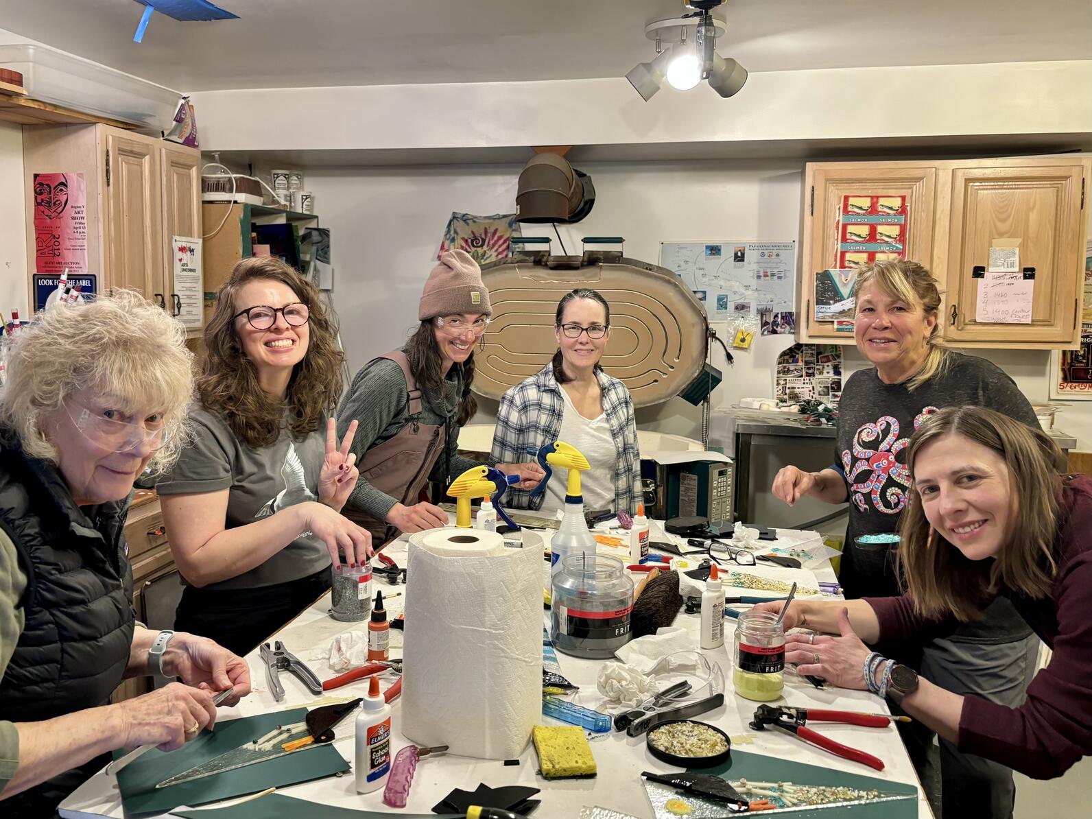 Six women standing in art studio smiling