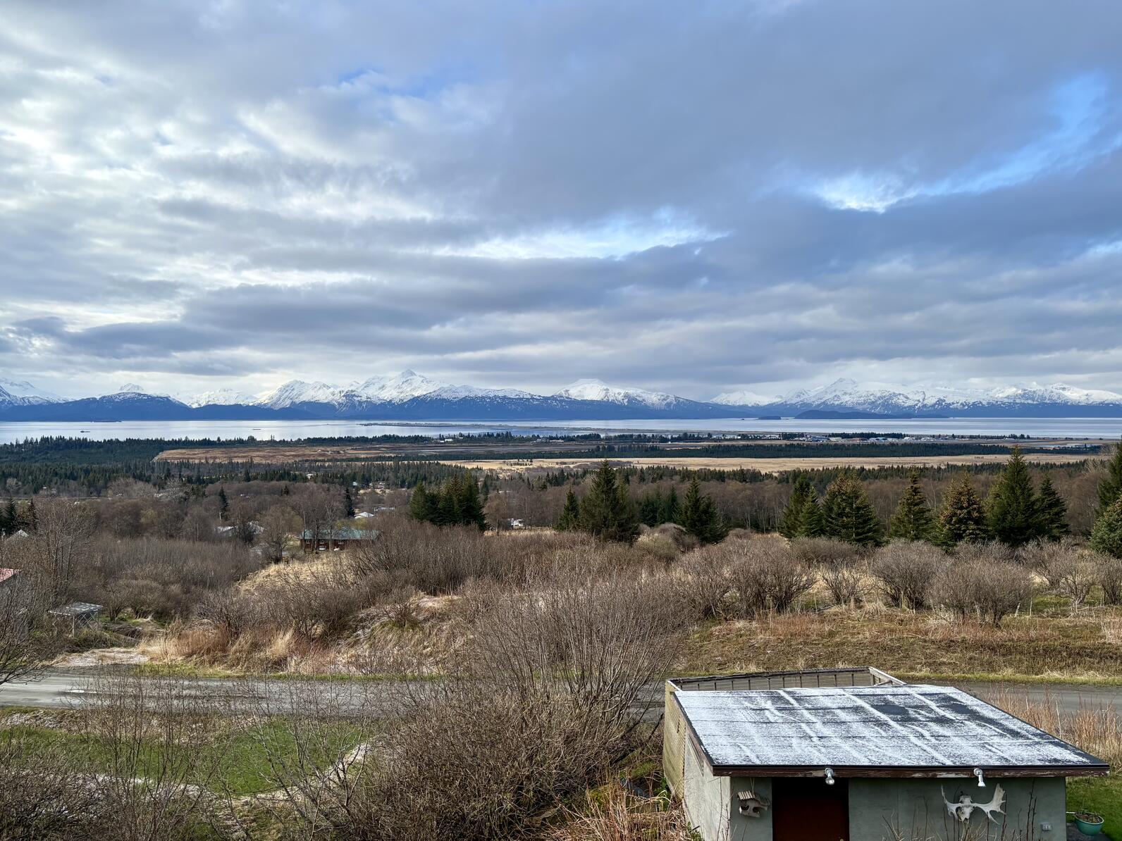 View of bay and mountains with cloudy skies